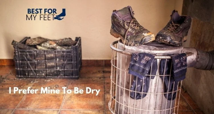 a pair of wet work boots and socks put to dry on the stove