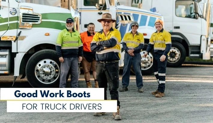 a group of truck drivers taking a picture in front of their trucks.