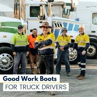 a group of truck drivers taking a picture in front of their trucks.